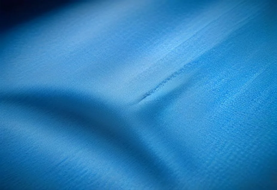 A microfibre cloth wiping a stainless steel surface streak-free